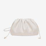 De Serena Zachte Leren Pouch Tas van Liora The Label is een zachte, witte tas van boterzacht leer met een minimalistisch ontwerp en een koordsluiting, afgebeeld tegen een effen witte achtergrond.