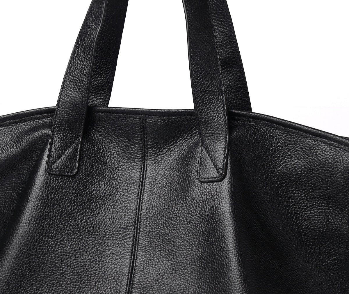 Close-up van de Caro Oversized Leren Tote van Liora The Label, een zwarte minimalistische draagtas met zachte structuur, gemaakt van vegan leer en ontworpen voor dagelijks gebruik, met focus op de handvatten en de textuur.